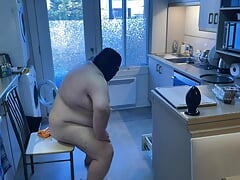 Pluged SuperChub cleans his kitchen