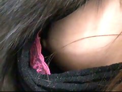 A downblouse view of an Asian girl