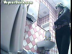 Curly haired white sweetheart filmed from behind in the toilet