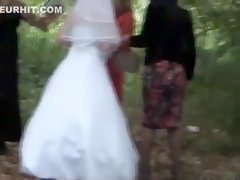 Bridesmaids helping the bride to pee