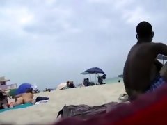 Naked black and white women filmed at the beach