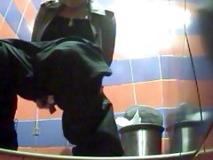 Nasty curly brunette is peeing in a sexy toilet