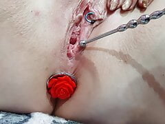 Sounding masturbation of a pierced pussy with an anal plug